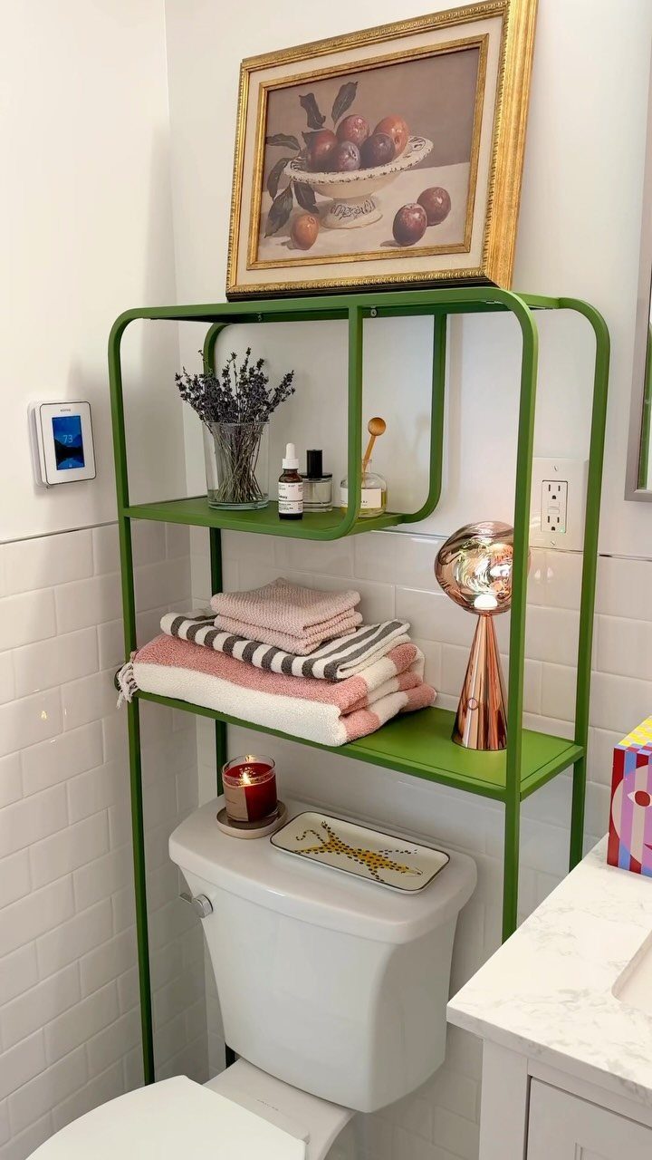 19 Teen Bathroom Ideas That Blend Style and Function 20 Green over-the-toilet shelving unit with towels and decor in a white tiled bathroom.